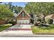 Charming brick home with mature trees, two-car garage and manicured landscaping at 35 Westfair Ct, Atlanta, GA 30328