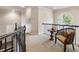 Upstairs hallway featuring a chair, table, carpeted floor, and an arched window, creating an inviting space at 35 Westfair Ct, Atlanta, GA 30328