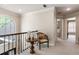 Open hallway with railing and a decorative chair and table near a window offering natural light at 35 Westfair Ct, Atlanta, GA 30328