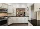 Updated kitchen features granite counters, white cabinets, tile backsplash, and stainless appliances at 35 Westfair Ct, Atlanta, GA 30328