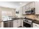 Bright kitchen featuring granite countertops, stainless steel appliances, and an open dining area at 35 Westfair Ct, Atlanta, GA 30328