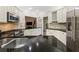 Well-appointed kitchen featuring granite countertops, white cabinetry, and stainless steel appliances at 35 Westfair Ct, Atlanta, GA 30328
