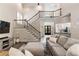 Bright living room with soaring ceilings showcasing a staircase and a view into the kitchen at 35 Westfair Ct, Atlanta, GA 30328