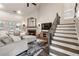 Inviting living room features a fireplace, vaulted ceiling, plush seating, and staircase with iron balusters at 35 Westfair Ct, Atlanta, GA 30328