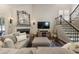 Comfortable living room featuring a stone fireplace, TV, staircase and neutral decor at 35 Westfair Ct, Atlanta, GA 30328