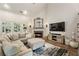 Cozy living room with a fireplace, hardwood floors, and large sectional sofa at 35 Westfair Ct, Atlanta, GA 30328