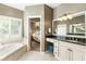 Bright main bathroom with soaking tub, double sink vanity, and an adjoining bedroom at 35 Westfair Ct, Atlanta, GA 30328