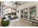 Relaxing sunroom with tiled floor, comfortable seating, ceiling fan, and ample natural light through large windows at 35 Westfair Ct, Atlanta, GA 30328