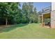 Spacious backyard with lush lawn and mature trees, perfect for outdoor activities and relaxation at 4445 Hager Ct, Cumming, GA 30040