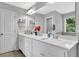 Bright bathroom featuring double vanities with quartz countertops, providing ample space and style at 4445 Hager Ct, Cumming, GA 30040