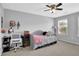 Cozy bedroom showcasing a daybed, ceiling fan, and natural light from the window at 4445 Hager Ct, Cumming, GA 30040