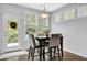 Cozy dining area featuring natural light, a modern light fixture, and a door to the outside at 4445 Hager Ct, Cumming, GA 30040
