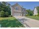 Charming brick home with a well-manicured lawn, inviting front porch and long concrete driveway at 4445 Hager Ct, Cumming, GA 30040