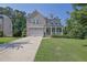 Attractive brick home with a welcoming front porch, neat landscaping, and a long driveway at 4445 Hager Ct, Cumming, GA 30040