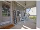 Charming front porch with rocking chairs, a welcome sign, and stylish brick accents at 4445 Hager Ct, Cumming, GA 30040