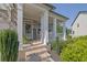 Inviting front porch with classic white columns and brick accents, creating a warm entrance at 4445 Hager Ct, Cumming, GA 30040
