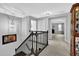 Upstairs hallway with a pendant light fixture and a dark wood railing at 4445 Hager Ct, Cumming, GA 30040