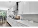Bright kitchen features white cabinets, stainless steel appliances, and a subway tile backsplash at 4445 Hager Ct, Cumming, GA 30040