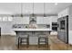 Modern kitchen with stainless steel appliances, a large island, and stylish pendant lighting at 4445 Hager Ct, Cumming, GA 30040
