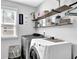 Well-organized laundry room with shelving and a front-load washer and dryer at 4445 Hager Ct, Cumming, GA 30040