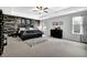 Spacious main bedroom with a wood accent wall, ceiling fan, and two windows at 4445 Hager Ct, Cumming, GA 30040