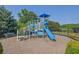 Community playground with a blue slide, climbing structures, and bench, perfect for enjoyment at 4445 Hager Ct, Cumming, GA 30040