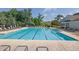 Large community swimming pool surrounded by lounge chairs, ideal for relaxation and recreation at 4445 Hager Ct, Cumming, GA 30040