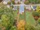 Areal view of the property's backyard, fence, mature trees and a partial view of a screened porch at 474 Haley Se St, Marietta, GA 30060