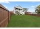 Spacious backyard featuring lush green lawn, privacy fence, and an outdoor patio with stairs at 474 Haley Se St, Marietta, GA 30060