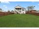 Expansive backyard featuring lush lawn and a home with an outdoor patio with stairs at 474 Haley Se St, Marietta, GA 30060