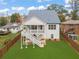 Back exterior featuring a large backyard, wooden fence, and stairs to a second level outdoor living space at 474 Haley Se St, Marietta, GA 30060