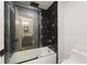 Modern bathroom with black and white tiled shower and glass doors at 474 Haley Se St, Marietta, GA 30060