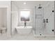 Modern bathroom featuring a soaking tub, a glass-enclosed shower, and marble accents at 474 Haley Se St, Marietta, GA 30060