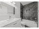 Modern bathroom features tub with gray tile surround, stylish fixtures, and granite vanity at 474 Haley Se St, Marietta, GA 30060