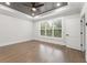 Spacious bedroom with hardwood floors, a tray ceiling with a fan, and a large window at 474 Haley Se St, Marietta, GA 30060