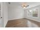 Bedroom featuring hardwood floors, ceiling fan, and window with blinds, neutral wall paint throughout at 474 Haley Se St, Marietta, GA 30060