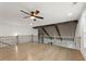 Open bonus room featuring hardwood floors, a ceiling fan, and a decorative iron railing at 474 Haley Se St, Marietta, GA 30060