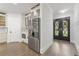 Hallway featuring modern stainless steel refrigerator, and view of the home's double door entry at 474 Haley Se St, Marietta, GA 30060