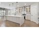 Bright, modern kitchen features a large island, pendant lighting, and stainless steel appliances at 474 Haley Se St, Marietta, GA 30060