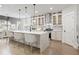 Bright, modern kitchen features a large island, pendant lighting, and stainless steel appliances at 474 Haley Se St, Marietta, GA 30060