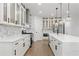Modern kitchen with marble backsplash, stainless steel appliances, and glass-front cabinets at 474 Haley Se St, Marietta, GA 30060