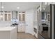 Modern kitchen featuring glass-front cabinets, marble backsplash, and stainless steel appliances at 474 Haley Se St, Marietta, GA 30060