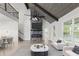 Open-concept living room featuring high ceilings, a stone fireplace, and stylish furnishings at 474 Haley Se St, Marietta, GA 30060