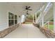 Covered outdoor patio featuring stone accents, ceiling fans, and outdoor stairs at 474 Haley Se St, Marietta, GA 30060