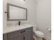 Stylish powder room with gray vanity, marble countertop, modern fixtures, and a framed mirror at 474 Haley Se St, Marietta, GA 30060