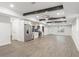 Open recreation room showcasing kitchen with stainless appliances, light colored walls, luxury vinyl floors and ceiling beams at 474 Haley Se St, Marietta, GA 30060