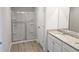 Bathroom featuring double sink vanity with granite countertops, a large mirror, and a tiled shower at 15 Barton Ln, Covington, GA 30016