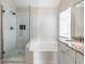 Bright bathroom featuring a tiled glass shower, bathtub, and granite-topped vanity at 2348 Logan Ne Cir, Brookhaven, GA 30319