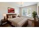 Comfortable bedroom featuring a queen-sized bed, neutral decor, and abundant natural light from a bright window at 2348 Logan Ne Cir, Brookhaven, GA 30319