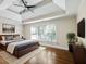 Relaxing bedroom with tray ceiling, hardwood floors, and large windows at 2348 Logan Ne Cir, Brookhaven, GA 30319